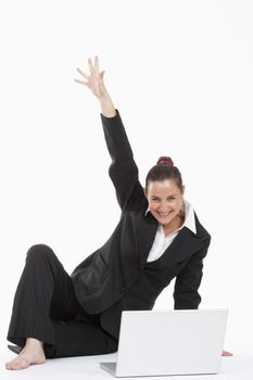 young beautiful businesswoman sitting in front of her laptop cheering