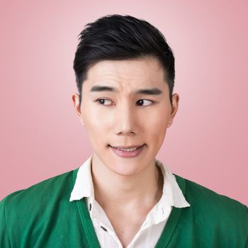 Funny facial expression, closeup Asian young man.