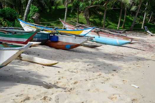 Sri Lankan boats on sandy beach in Tangalle, Southern Province, Sri Lanka, Asia.