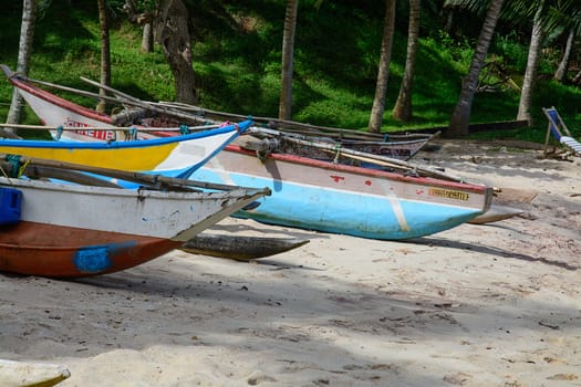 Sri Lankan boats on sandy beach in Tangalle, Southern Province, Sri Lanka, Asia.