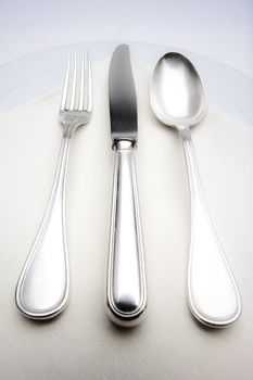 elegant table setting with silverware on white cloth