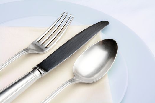 elegant table setting with silverware on white cloth