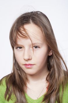 studio portrait of a pretty, eleven years old girl