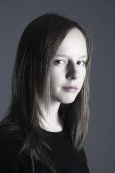 studio portrait of a pretty, eleven years old girl