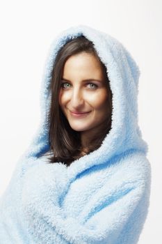 attractive brunette in blue bathrobe with hood isolated on white