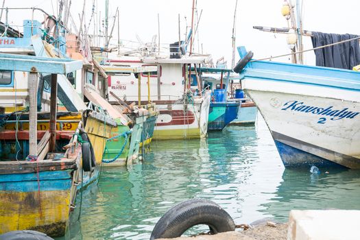 TANGALLE, SOUTHERN PROVINCE, SRI LANKA, ASIA - DECEMBER 20, 2014: Colorful wood fishing boats moored on December 20, 2014 in Tangalle port, Southern Province, Sri Lanka.