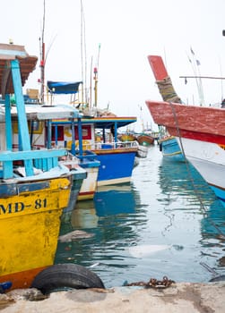 TANGALLE, SOUTHERN PROVINCE, SRI LANKA, ASIA - DECEMBER 20, 2014: Colorful wood fishing boats moored on December 20, 2014 in Tangalle port, Southern Province, Sri Lanka.