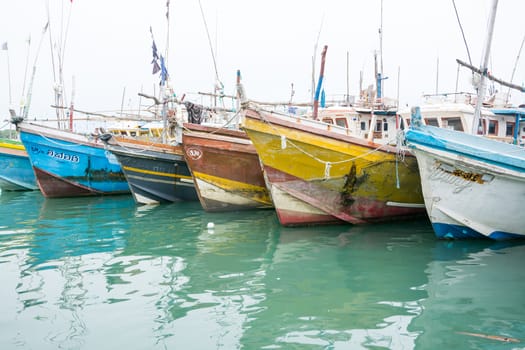 TANGALLE, SOUTHERN PROVINCE, SRI LANKA, ASIA - DECEMBER 20, 2014: Colorful wood fishing boats moored on December 20, 2014 in Tangalle port, Southern Province, Sri Lanka.