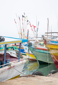 TANGALLE, SOUTHERN PROVINCE, SRI LANKA, ASIA - DECEMBER 20, 2014: Colorful wood fishing boats moored on December 20, 2014 in Tangalle port, Southern Province, Sri Lanka.