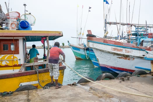 TANGALLE, SOUTHERN PROVINCE, SRI LANKA, ASIA - DECEMBER 20, 2014: Colorful wood fishing boats moored on December 20, 2014 in Tangalle port, Southern Province, Sri Lanka.