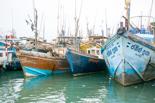 TANGALLE, SOUTHERN PROVINCE, SRI LANKA, ASIA - DECEMBER 20, 2014: Colorful wood fishing boats moored on December 20, 2014 in Tangalle port, Southern Province, Sri Lanka.