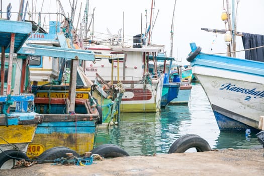 TANGALLE, SOUTHERN PROVINCE, SRI LANKA, ASIA - DECEMBER 20, 2014: Colorful wood fishing boats moored on December 20, 2014 in Tangalle port, Southern Province, Sri Lanka.