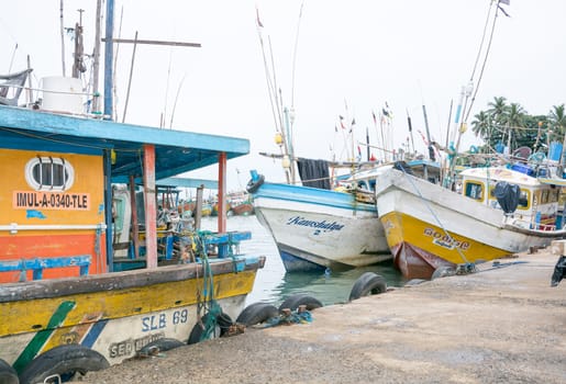 TANGALLE, SOUTHERN PROVINCE, SRI LANKA, ASIA - DECEMBER 20, 2014: Colorful wood fishing boats moored on December 20, 2014 in Tangalle port, Southern Province, Sri Lanka.