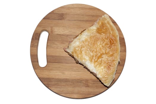 Balkan pie burek on the wooden board.