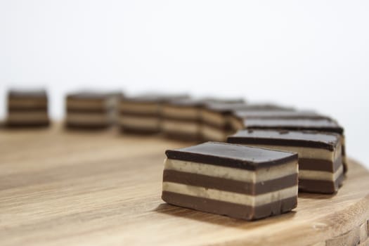Chocolate cakes lined up on the wooden board.