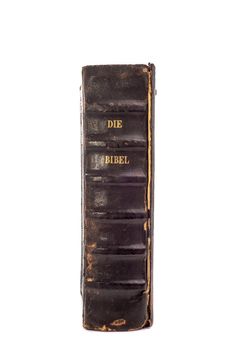 Old Dutch Bible standing upright on an isolated white background with the back of the book and the words "Die Bibel" clearly visible.