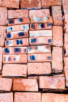 bricks lying stacked in a pattern showing lines, shapes and colours as viewed from above.