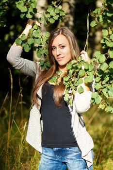 Portrait of smiling and charming lady woman girl outdoor with forrest in background 