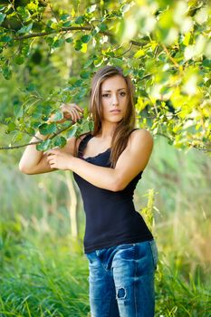 Portrait of smiling and charming lady woman girl outdoor with forrest in background 