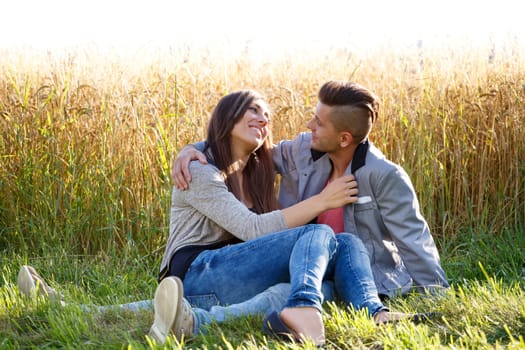 portrait of happy smiling young couple in love embracing outdoor at sunny day