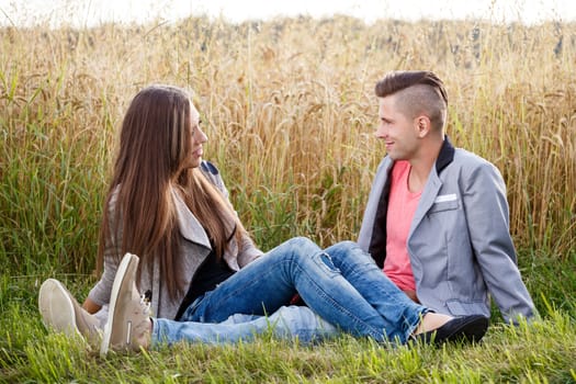 portrait of happy smiling young couple in love embracing outdoor at sunny day