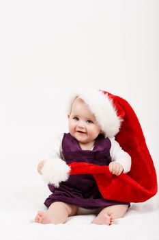 Child girl with Christmas santa hat on white background