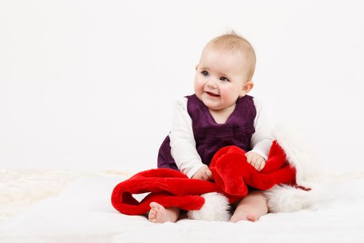 Child girl with Christmas santa hat on white background