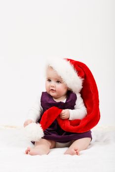 Child girl with Christmas santa hat on white background