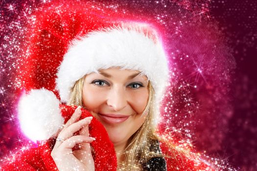 Joyful pretty woman in red santa claus hat smiling on abstract red  background