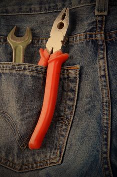 wrench and pliers in jeans pocket, instagram image style
