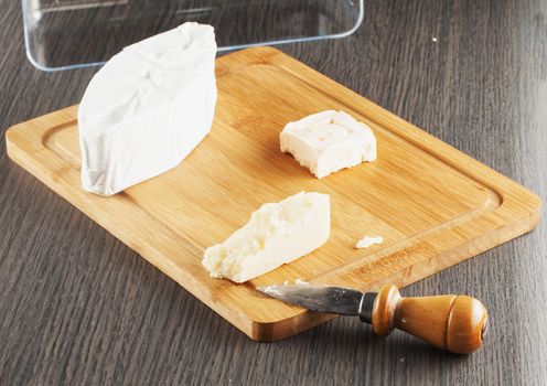 Italian and French cheese over chopping board