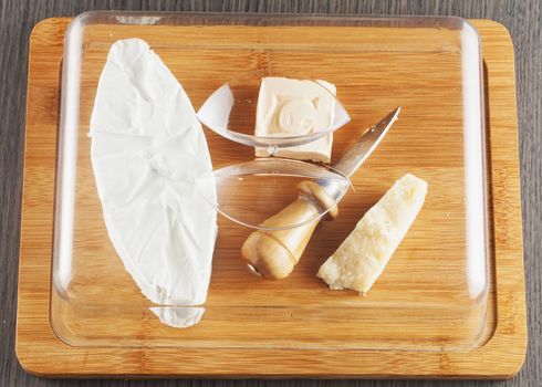 Different types of cheese over chopping board
