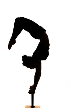 one caucasian woman contortionist practicing gymnastic yoga in silhouette on white background 