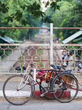 YANGON, MYANMAR - NOVEMBER 12, 2014: Bicycle taxi, or cyclo, parked on a railway bridge in Yangon, Myanmar. The cyclo is an important mode of transportation in the Myanmar capital, where motorbikes are forbidden.
