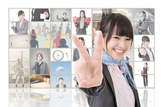 Confident Asian business woman give you a victory sign and standing in front of TV screen wall, closeup portrait.
