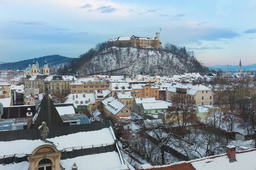 Panoramic view of Ljubljana, capital of Slovenia. Roofs covered in snow in winter time.