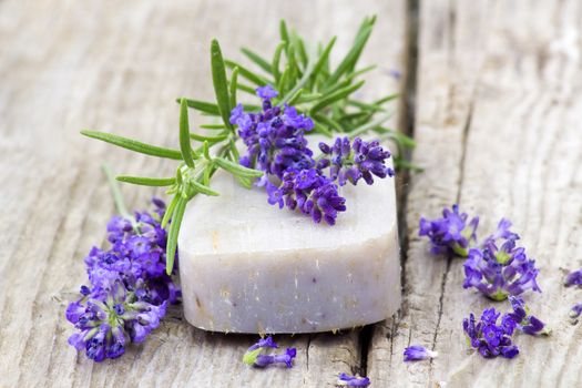 bar of natural soap, lavender flowers and rosemary