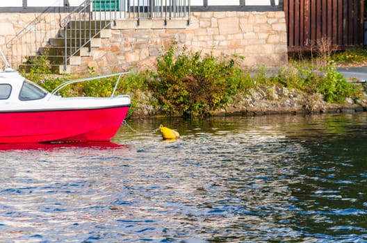 Small motorboat in the water in a bay at anchor.