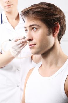 Portrait of a young man groomed during the treatment in the beauty salon