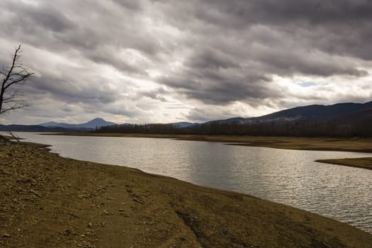 Plastiras lake view with dramatic cloudy sky, in central Greece