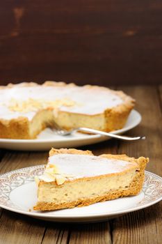 Banana tart piece on wooden background with space