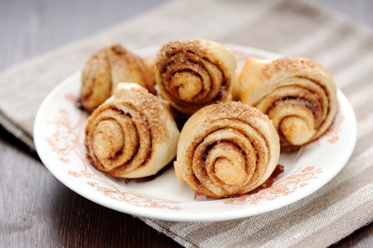 Cinnamon rolls on white plate with stripe napkin