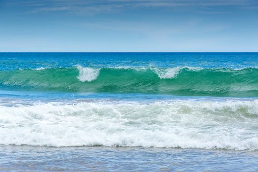 Green wave on sandy beach near Tangalle, Southern Province, Sri Lanka, Asia.