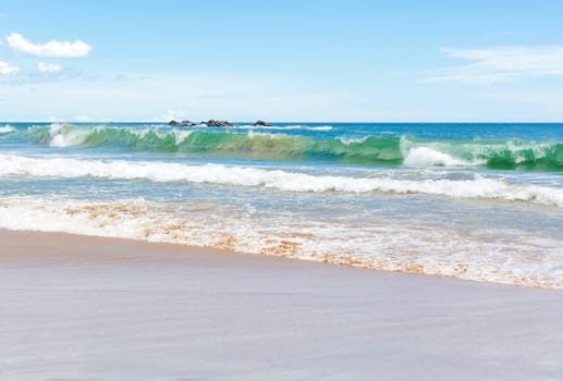 Green wave on sandy beach near Tangalle, Southern Province, Sri Lanka, Asia.