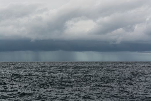 Tropical rain. Cloud, rain and horizon over Indian Ocean in December, Sri Lanka, Asia.