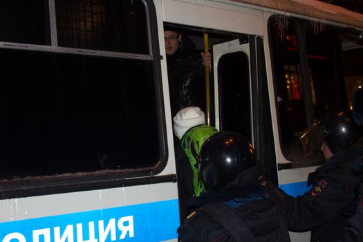 Moscow, Russia - December 30, 2014. In day of a sentence to the oppositional leader Alexei Navalny and his brother Oleg Navalny Muscovites came to a protest action to Manezhnaya Square. Police officers detain protesters in Moscow