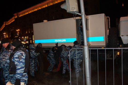 Moscow, Russia - December 30, 2014. In day of a sentence to the oppositional leader Alexei Navalny and his brother Oleg Navalny Muscovites came to a protest action to Manezhnaya Square. Police officers detain protesters in Moscow