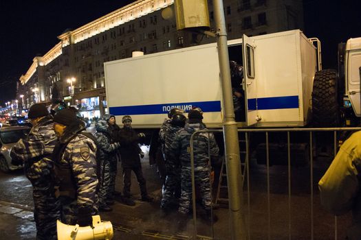 Moscow, Russia - December 30, 2014. In day of a sentence to the oppositional leader Alexei Navalny and his brother Oleg Navalny Muscovites came to a protest action to Manezhnaya Square. Police officers detain protesters in Moscow