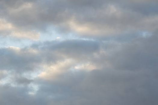 Blue sky with gray white clouds.

