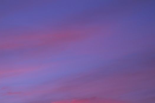 Sky with clouds in blue and pink purple sunset evening pastel colors photo.
